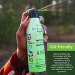 Hand holding and spraying a Natrapel Kids green repellent can outdoors with a green 'Kid-Friendly' info panel.