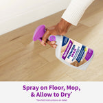 Hand spraying Rejuvenate PowerMax multi-surface floor cleaner onto a light wood floor with product label visible
