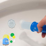Hand holding a blue dispenser stamping a small gel disc onto the inside of a toilet bowl
