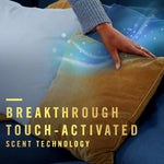 Lifestyle-style image of a hand touching a mustard pillow with illustrated scent waves and text about touch-activated scent technology.