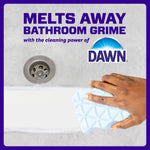 Hand using a blue Mr. Clean Magic Eraser on a tub surface with Dawn logo and text about melting away bathroom grime