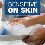 Close-up of hands washing a plate with thick foamy suds, overlaid with a 'Sensitive on Skin' message.