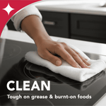 Hand wiping a glass cooktop with a white cloth emphasizing cleaning action and a sparkle graphic in corner
