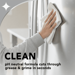 Hand wiping a stainless steel refrigerator door with a cloth, overlay text describing a pH neutral cleaning formula.