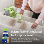 Close-up of a handheld upholstery tool cleaning a carpeted stair with BISSELL portable cleaner visible and product bottle inset.