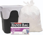 Large tied white trash bag standing next to a black wastebasket with a Handi-Bag product box placed in front