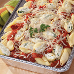 Aluminum foil pan filled with stuffed pasta shells topped with sauce and melted cheese
