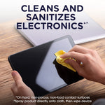 Close-up of hands cleaning a tablet screen on a wood table with accompanying headline about sanitizing electronics