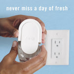 Hands holding a Febreze plug refill near a wall outlet with overlaid copy reading 'never miss a day of fresh'.