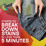Close-up of hands holding stained jeans with Shout logo and text about breaking down stains in five minutes