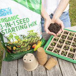 Hands holding potting mix next to a planting tray, peat pots and a large Back to the Roots seed starting mix bag outdoors