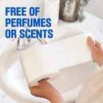 Hands holding a sheet of white toilet paper over a bathroom sink with text ‘Free of perfumes or scents’