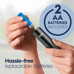 Close-up of hands inserting a blue AA battery into a black Oral‑B handle with a circular badge stating '2 AA batteries included' and text about replaceable batteries.