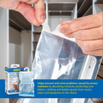 Close-up of hands peeling open a Humydry hanging bag seal with a small product box shown in the corner.