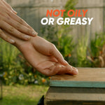 Hands shown over a wooden surface in an outdoor setting with prominent text stating ‘Not oily or greasy’