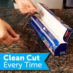 hands pulling plastic wrap from a reynolds kitchens box with slide cutter on a kitchen countertop