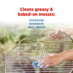 Hands scrubbing a round metal grill grate with a blue S.O.S steel wool pad under the headline about cleaning greasy messes.