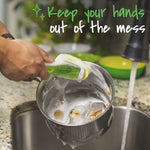Close-up of hands using a Scotch-Brite soap-dispensing dishwand to scrub the inside of a soapy pot