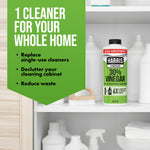 Cabinet shelf scene with a Harris 30% vinegar bottle among cleaning supplies and a green panel listing benefits for whole-home cleaning