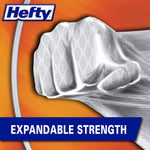 Close-up of a textured Hefty bag being punched by a fist graphic illustrating expandable strength with bold banner text
