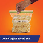Hand holding a Hefty double-zipper sandwich bag labeled "Potato Chips" against an orange background