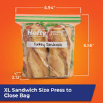 Hefty clear press-to-close bag holding two baguette sandwiches with dimensions and expandible bottom measurements shown