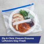 Hefty freezer bag on a countertop holding a plated meal with turkey, green beans and sweet potato, labeled with brand logo.