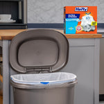 Kitchen scene with an open trash can lined with a white Hefty bag and Hefty Ultra Strong box on the counter