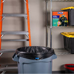 Garage scene with a trash can lined with a black Hefty bag and a Hefty Ultra Strong box on a metal shelf