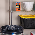 Hefty product box displayed on a metal shelf beside storage bins with a trash can lined with a black bag below