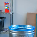 Hefty box on a wire shelf beside a metal trash can fitted with a blue trash bag lining.