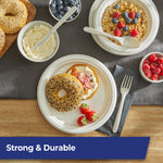Styled tabletop with bagel, fruit and Hefty ECOSAVE patterned fork, knife and spoon alongside paper plates