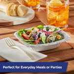 Patterned compostable fork resting on a napkin beside a salad bowl and iced tea, styled for everyday meal use