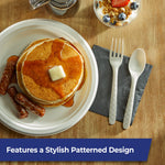 Styled tabletop with pancakes and a napkin beside a patterned compostable fork and spoon from Hefty ECOSAVE