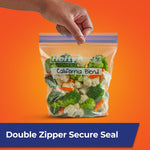 Hand holding a sealed Hefty stand-and-fill quart bag labeled “California Blend” filled with vegetables