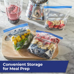 Three Hefty stand-and-fill bags with prepped fruit and vegetables arranged on a countertop near a blender