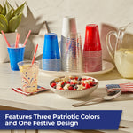 Styled tabletop scene showing stacks of Hefty red, white, blue and printed clear party cups with beverage and snacks