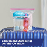 Hefty quart bag labeled Travel Toiletries sitting on top of a blue hard-shell suitcase showing travel storage use