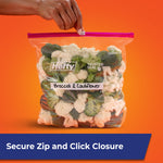 Hefty slider bag labeled 'Broccoli & Cauliflower' held at top against an orange background