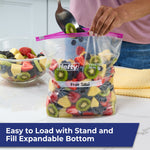 Hefty gallon slider bag filled with fruit salad on a counter, showing pink slider and handwritten label