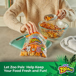Person scooping snack mix into a Hefty Zoo Pals zipper bag on a kitchen counter
