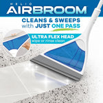 Close-up of a blue Helio AirBroom triangular flex head wiping debris from a tiled floor with marketing text