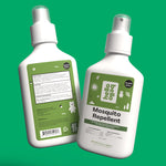 Two Hello Bello mosquito repellent spray bottles showing front and back labels on a green background.