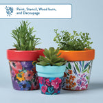 Three decorated and decoupaged terracotta pots with faux succulents, demonstrating painting and craft techniques