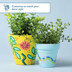 Two decorated painted pots with faux plants on a pale background, showcasing customizable decor styles