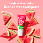 Hello fresh watermelon toothpaste tube surrounded by watermelon slices on a pink background with product name text.