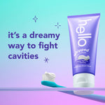 Purple Hello whipped toothpaste tube standing beside a toothbrush loaded with paste and text 'it's a dreamy way to fight cavities'