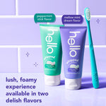 Two Hello whipped toothpaste tubes, purple and green, shown with a teal toothbrush and text about two delish flavors