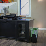 Office setting showing a trash can lined with a green-striped HERO Scent Stripes bag