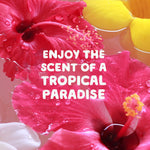 Close-up of pink hibiscus flowers floating in water with text enjoying the scent of a tropical paradise